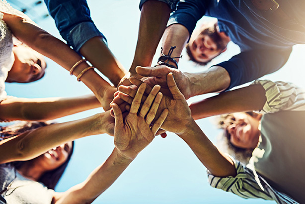 People with their hands in the center of the image